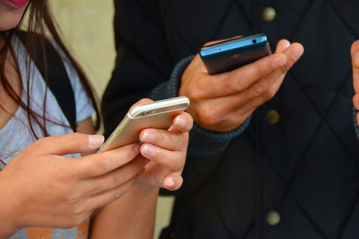 Two Students Checking Notification on their Phones