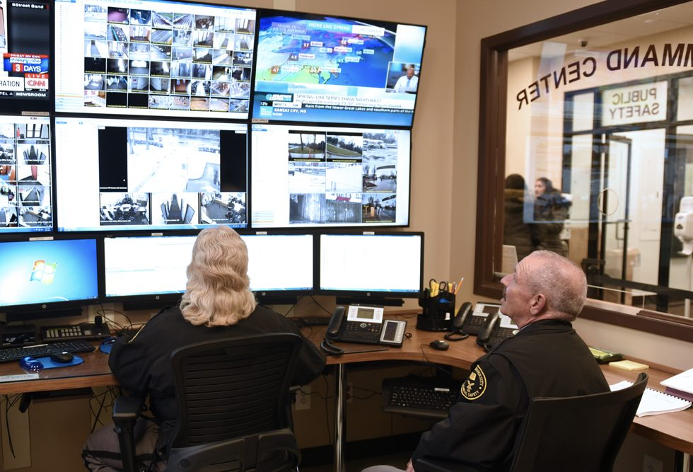 Two Public Safety Officers viewing security monitors. 