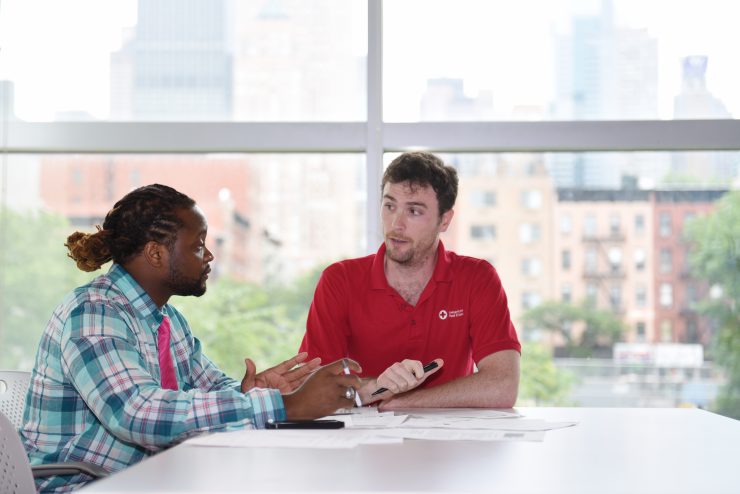 Two professionals sitting at a meeting table having a discussion