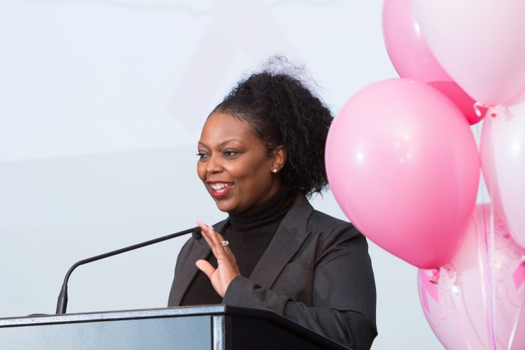 Breast Cancer Hotline at Adelphi - Event with speaker at podium with pink balloons