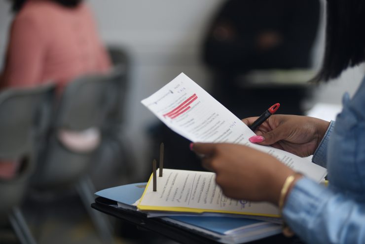 A student reviewing paperwork in the classroom