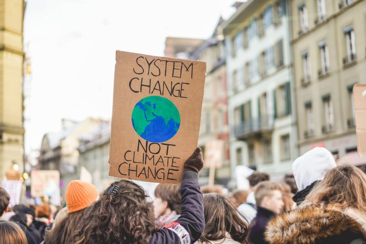 Group of demonstrators fight for climate change - Global warming and environment concept - Focus on banner