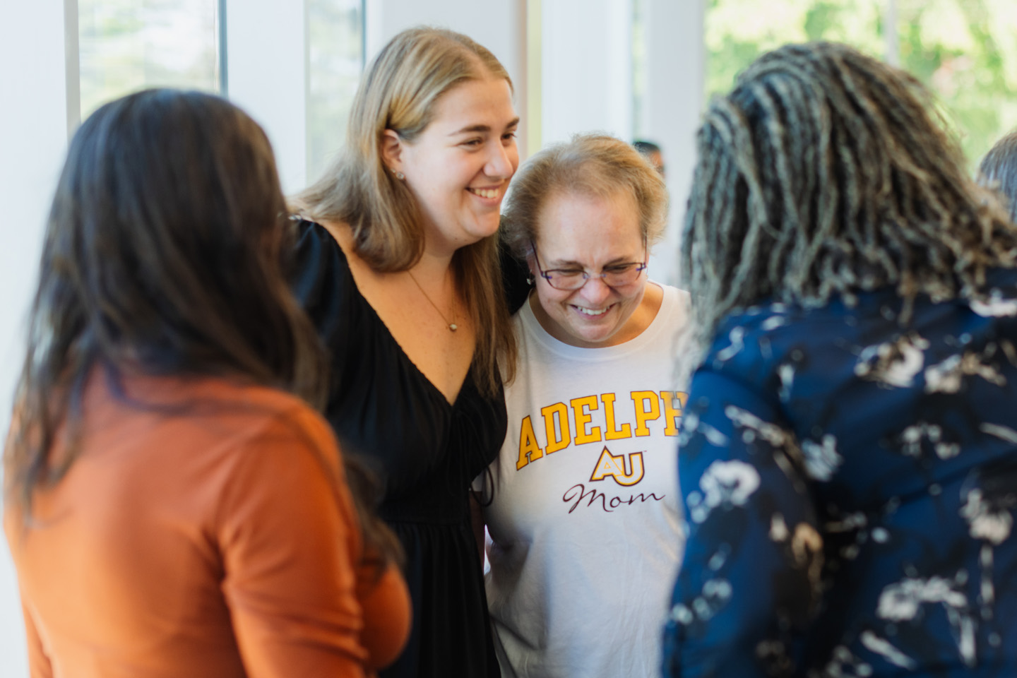 Adelphi moms share a happy moment with her student.
