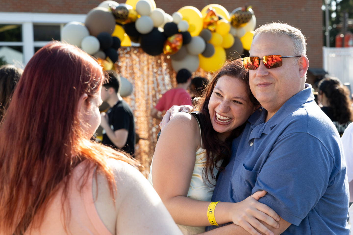 A man and his daughter hug at Spirit Weekend