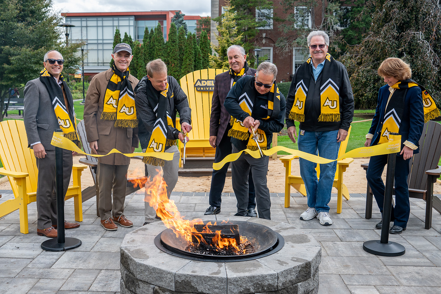 Adelphi campus leaders and donors cut a ribbon to celebrate the opening of the Panther Pit.
