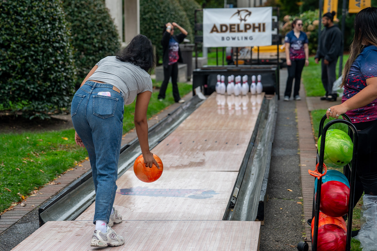 At a one-lane bowling alley on campus, one student gets ready to roll the ball.