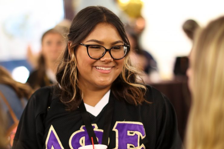 A sorority leader smiles during an event.