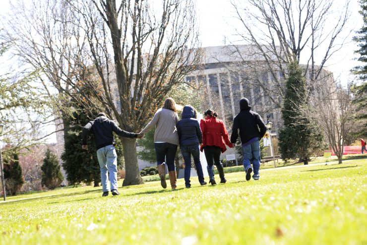 Students holding hands on campus