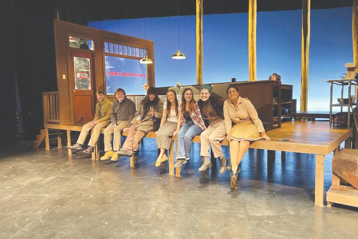 Seven students smiling, posing for the camera