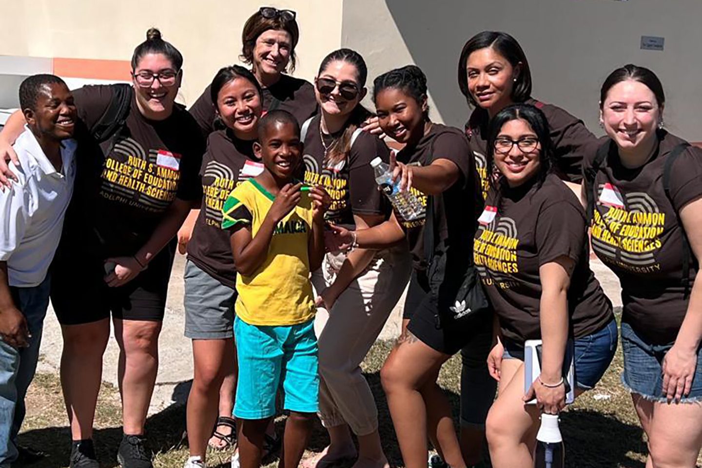 Katarzyna Nowicka, a first-year graduate student in Communication Disorders (Speech Language Pathology), with youngsters in Kingston, Jamaica