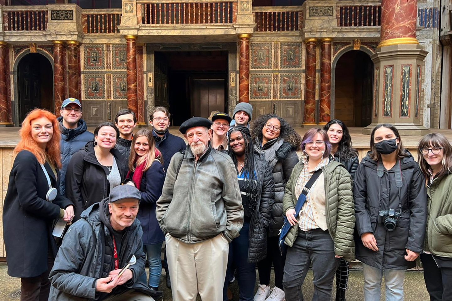 Sarah Gaetano (red scarf), a sophomore studying theatre acting with a design and technology minor, in front of the stage at Shakespeare’s Globe Theatre in London