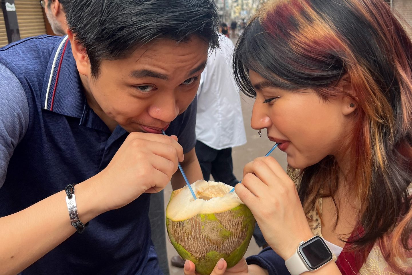 Josh Laureta ’26 and Kristen Flores share fresh coconut water, savoring a simple and refreshing part of daily life in India.