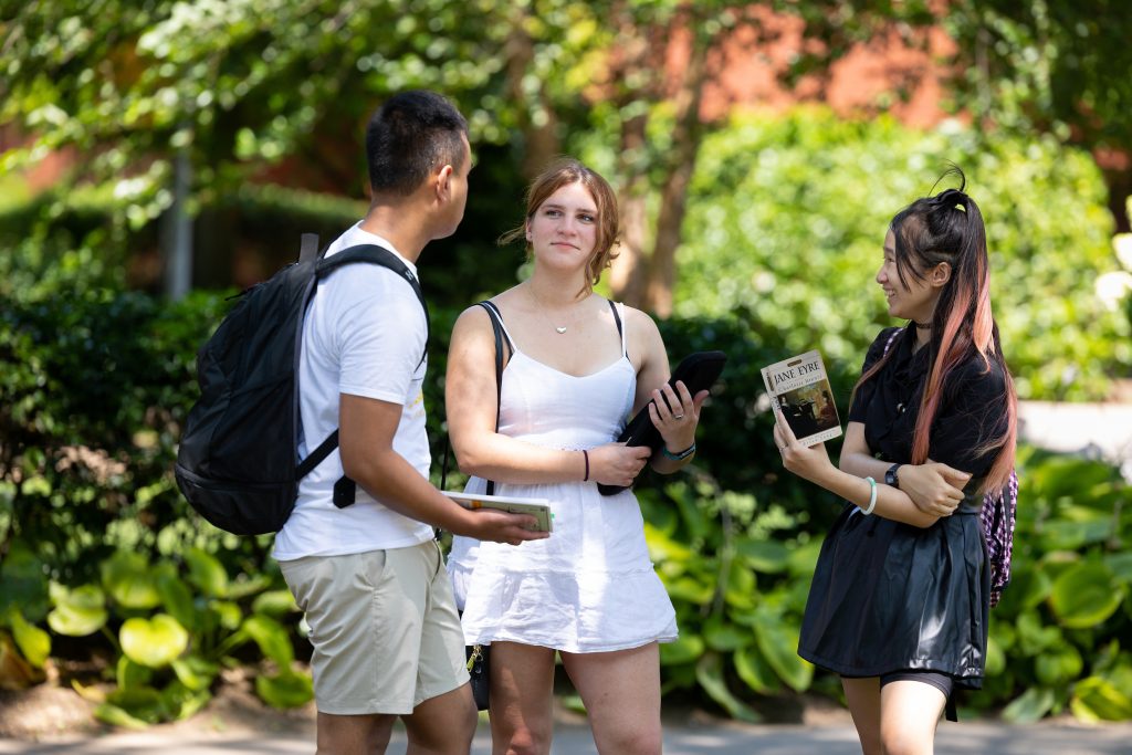 Adelphi students talking on campus.