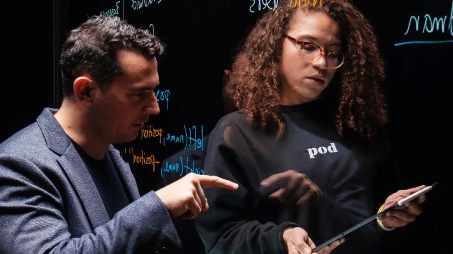 The Global Career Accelerator - instructor working on code with a student.