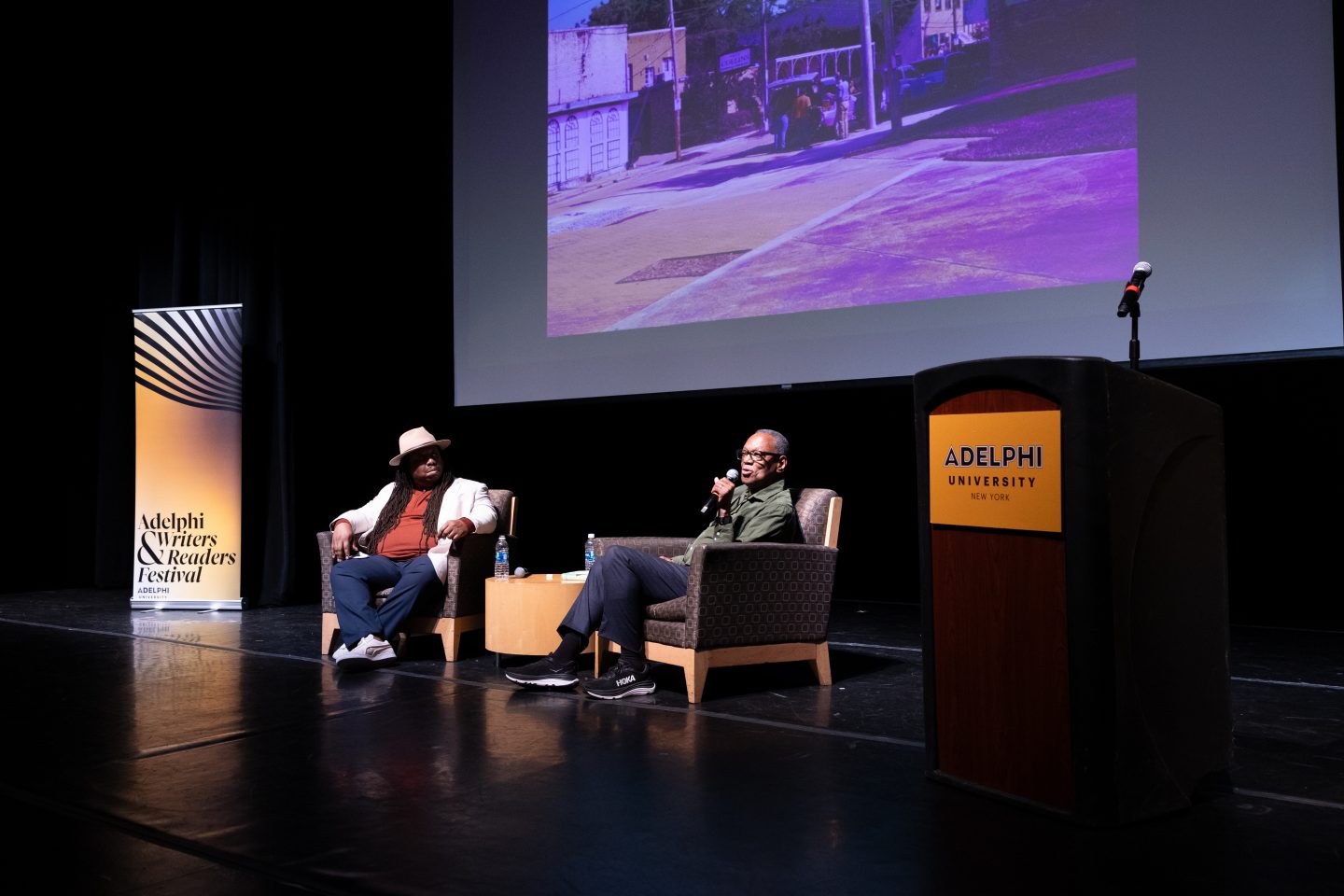 Alvin Hall (left) speaks with current MFA student Ed Mabrey about Hall’s book Driving the Green Book.”