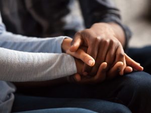 Hands holding in support