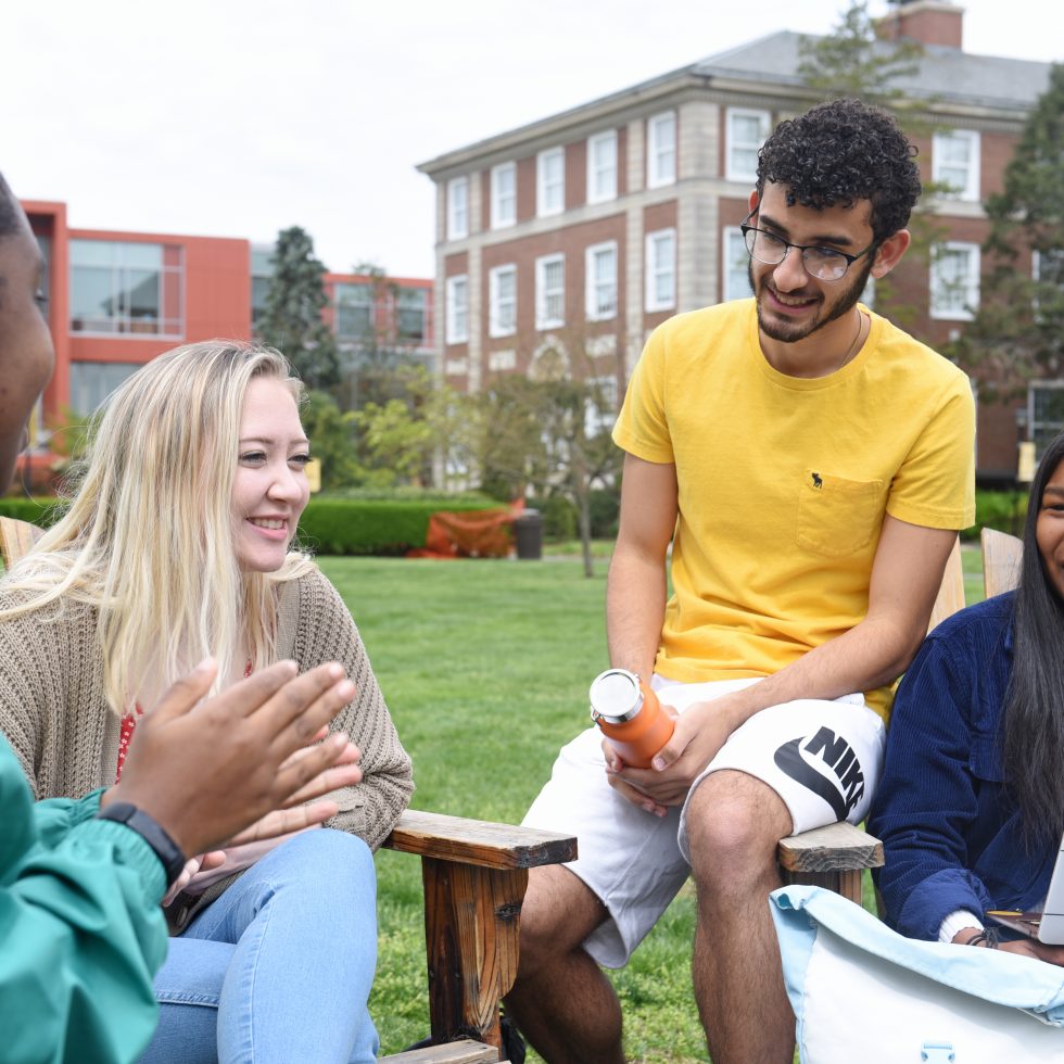 Students outside laughing in front of Levemore Hall