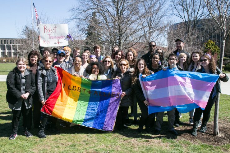 Adelphi students proudly holding flags for transgender and LGBTQIA+ pride
