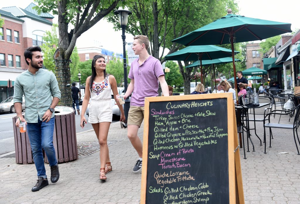 Adelphi students stroll 7th street in Garden City.