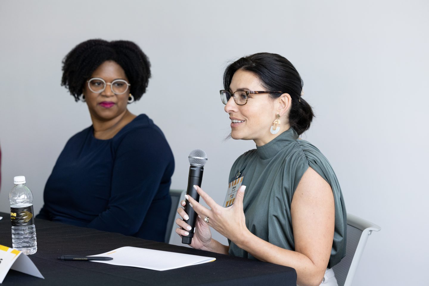 Two women in business attire share their stories.