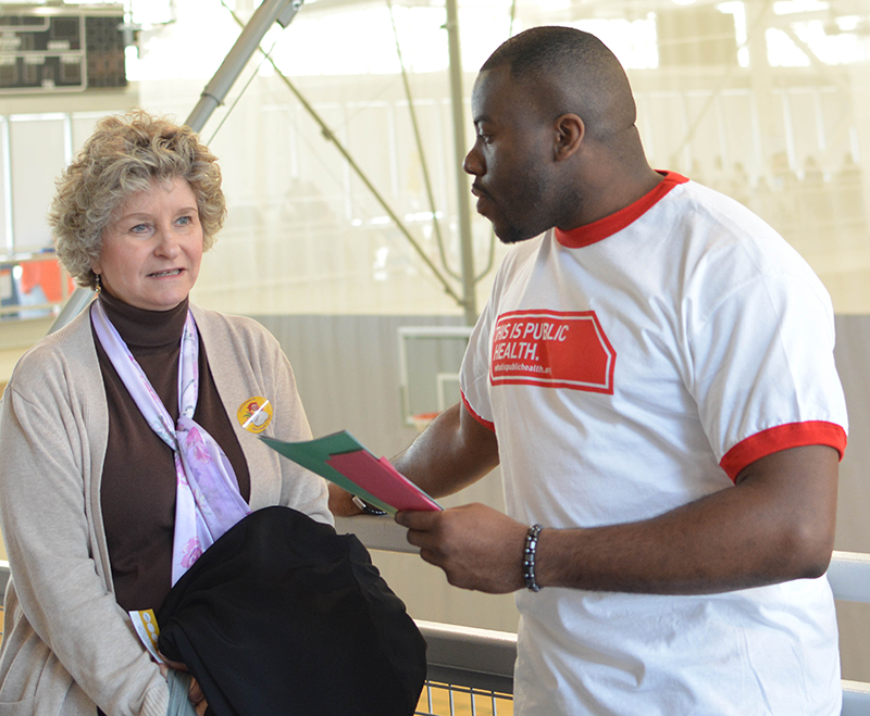 public health advocate talking with elderly woman
