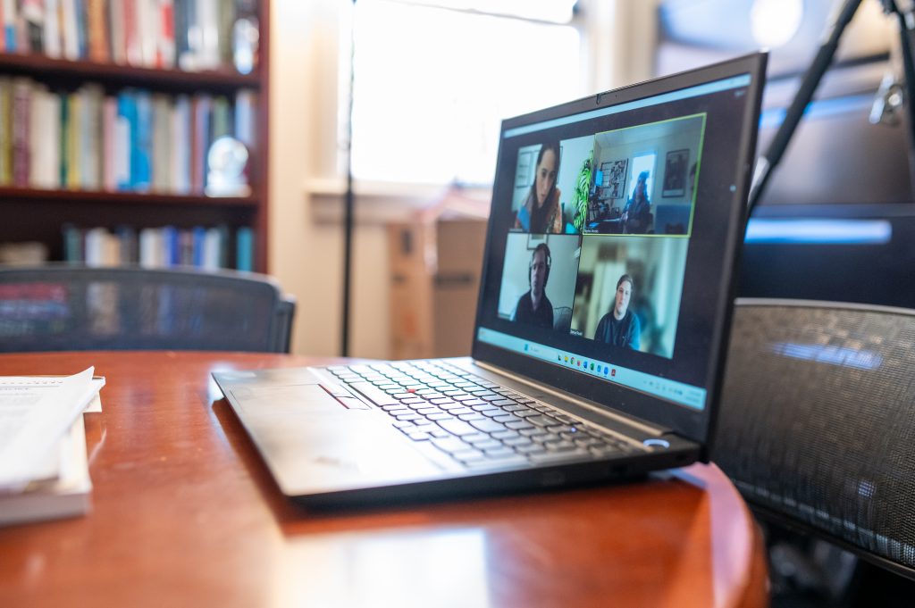 virtual call on a laptop in the office of the Derner School of Psychology Dean.