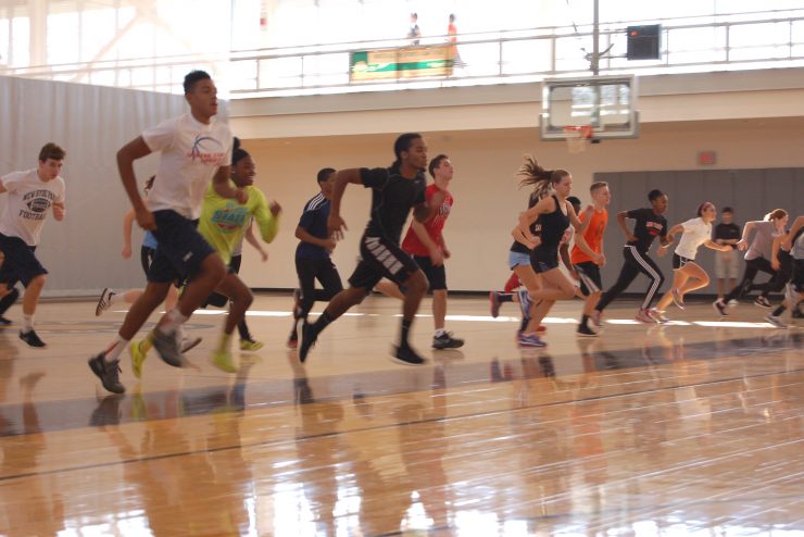 Most Physically Educated Contest Pacer Test: group of students running in a gymnasium