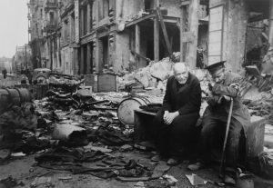 Two elderly German men sitting among the rubble of the Battle of Berlin in May of 1945.