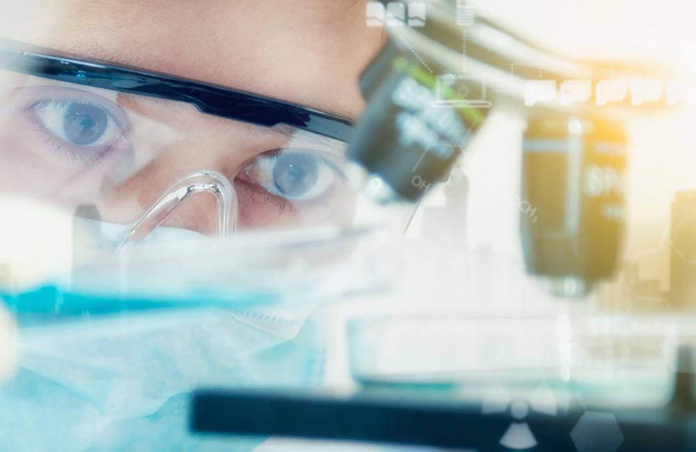 tight-focus photo of a scientist wearing goggles, using optics equipment, conducting an experiment