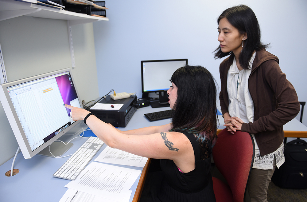  photo of speech pathology students anaylzing their work on a computer