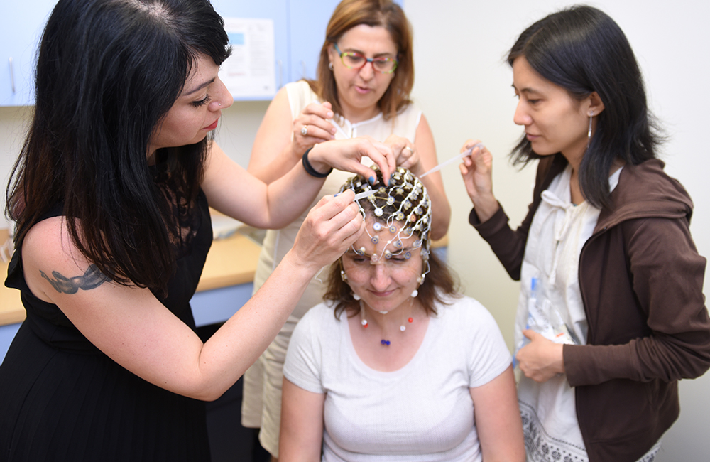 Adelphi students working with a sensor net for EEG