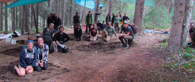 Group of people smiling for photo while surrounding their find.