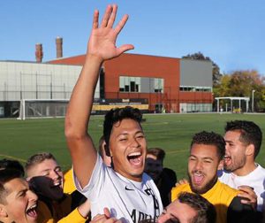 students cheering in a football field