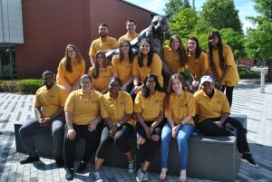 Commuter assistants sitting outside Center for Recreation and Sport building.