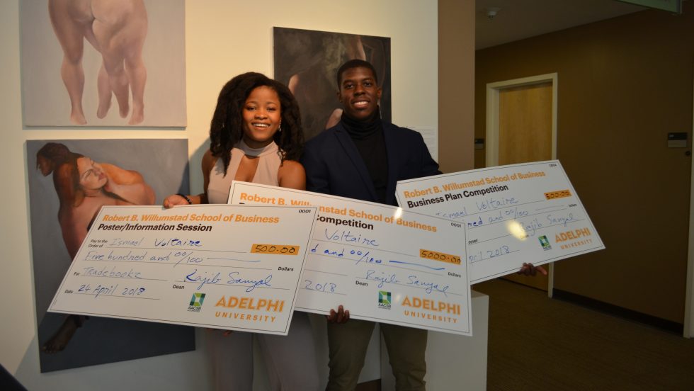 Winners of Adelphi University's first Business Plan Competition holding large checks