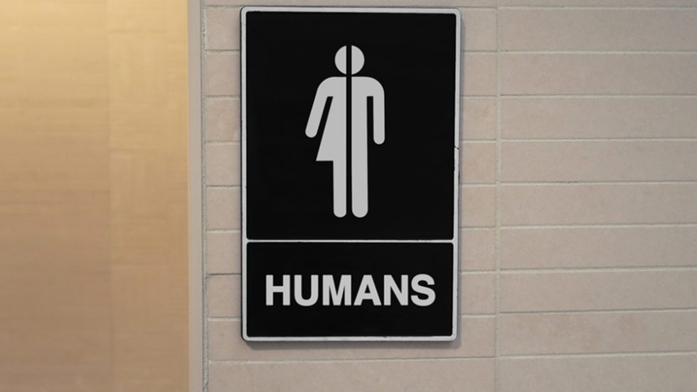 A bathroom sign showing all-gender symbol with the word "Humans"