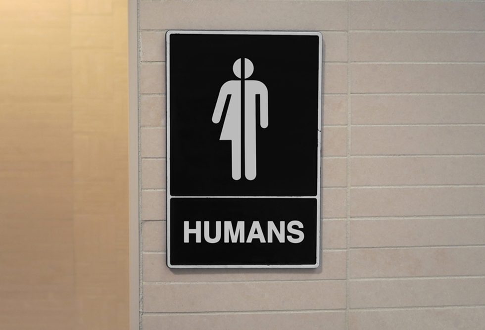 A bathroom sign showing all-gender symbol with the word "Humans"