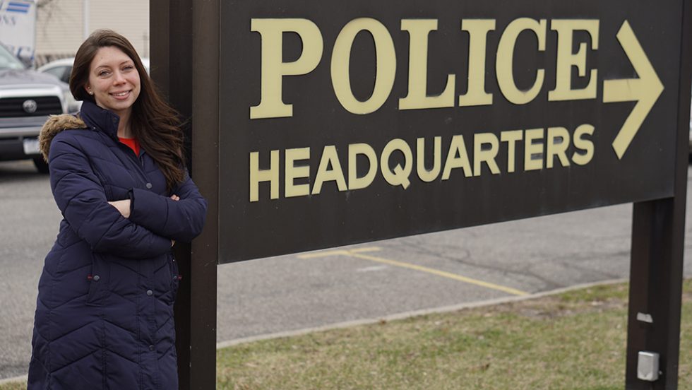 Cristin Sauter standing in front of the Police Headquarters sign in the City of Newburgh