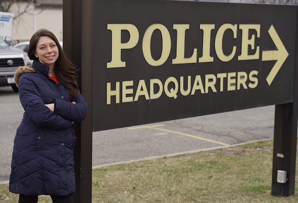 Cristin Sauter standing in front of the Police Headquarters sign in the City of Newburgh