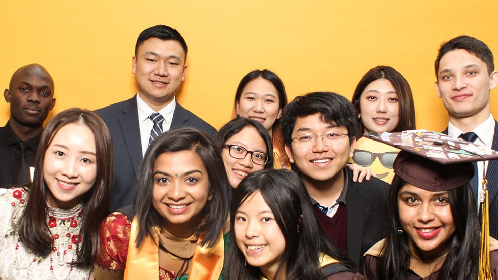International students gathered together in a photobooth at Adelphi