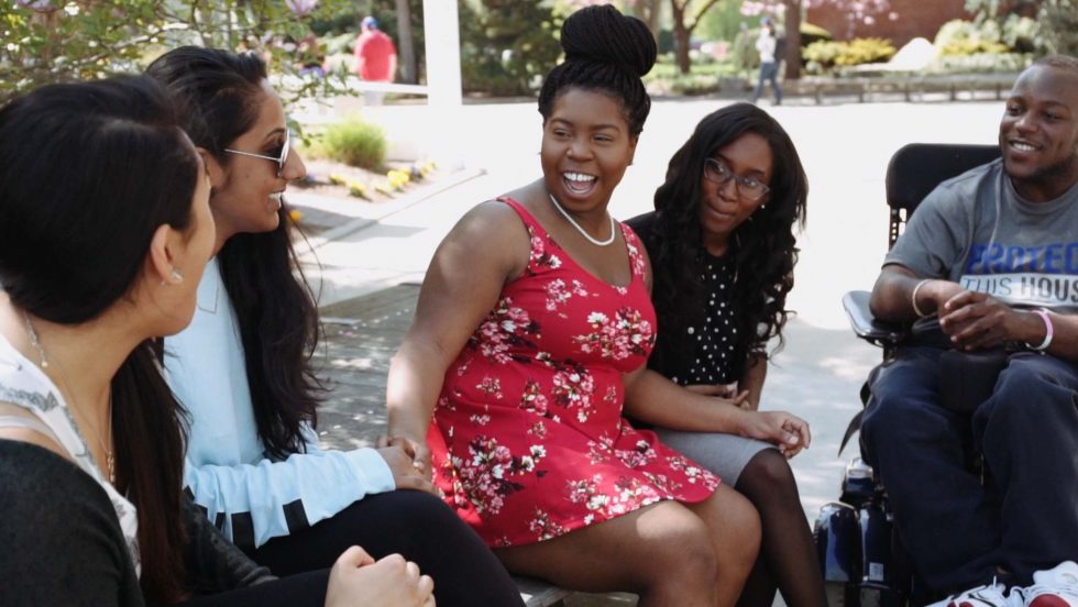 A diverse group of student talking and enjoying friendships at Adelphi