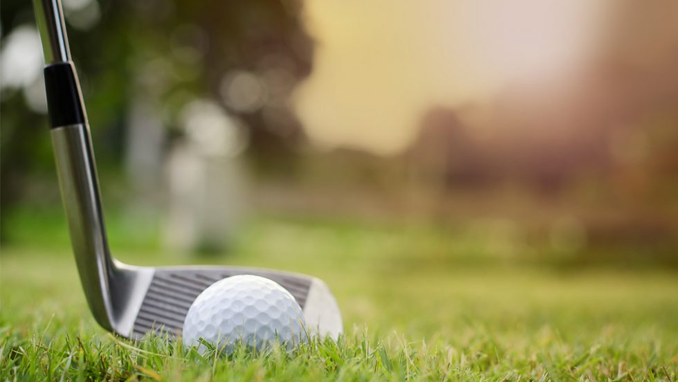 Golf Classic - a ball and putter on the green