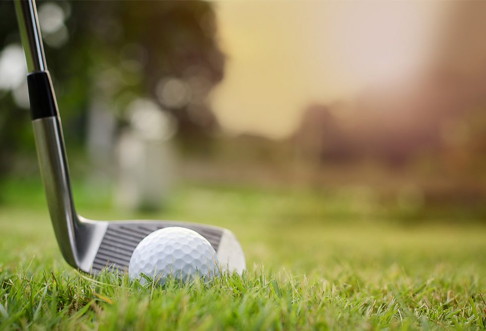 Golf Classic - a ball and putter on the green