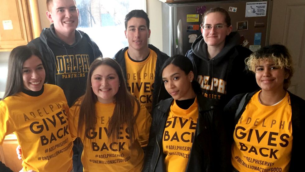 Students volunteering during Panther Day of Service - wearing give back t-shirts