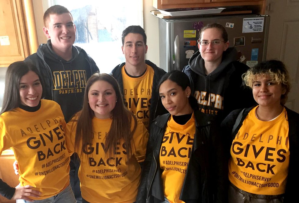 Students volunteering during Panther Day of Service - wearing give back t-shirts