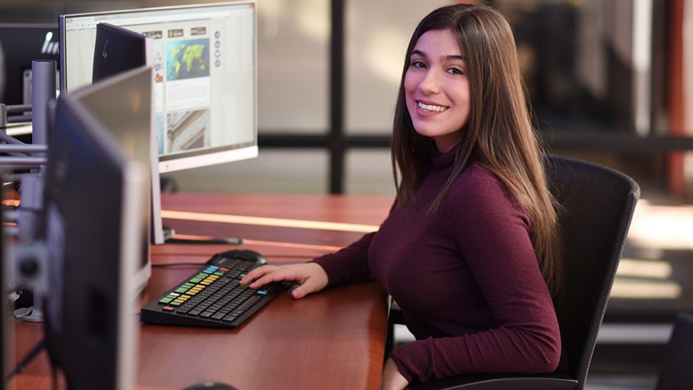 Christina Panouis, sitting at a computer