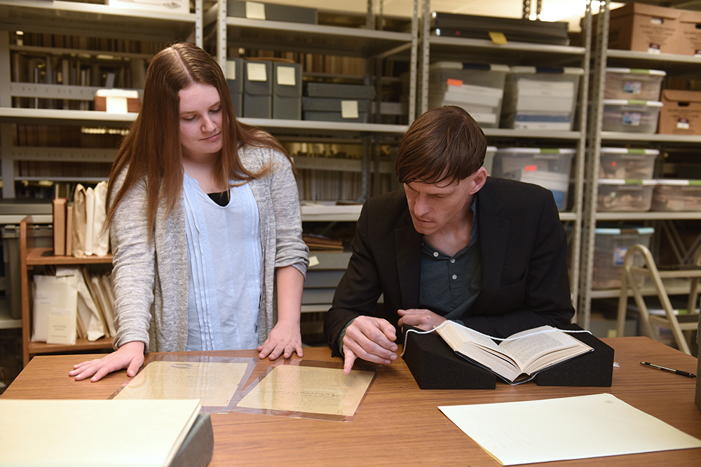 Nicole Quirke looking at old documents