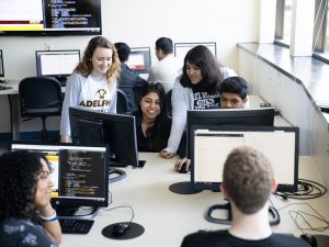 Adelphi University computer science classroom: students learning at monitors