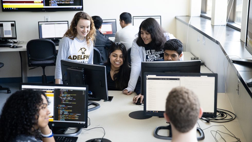 Adelphi University computer science classroom: students learning at monitors