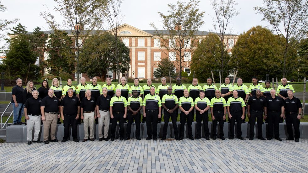Adelphi University Public Safety department staff group photo on the Garden City campus. Officers in uniform.